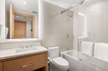 Step into a modern bathroom oasis, featuring sleek design and luxurious amenities.