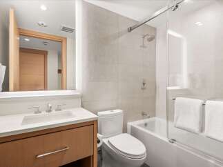 Step into a modern bathroom oasis, featuring sleek design and luxurious amenities.
