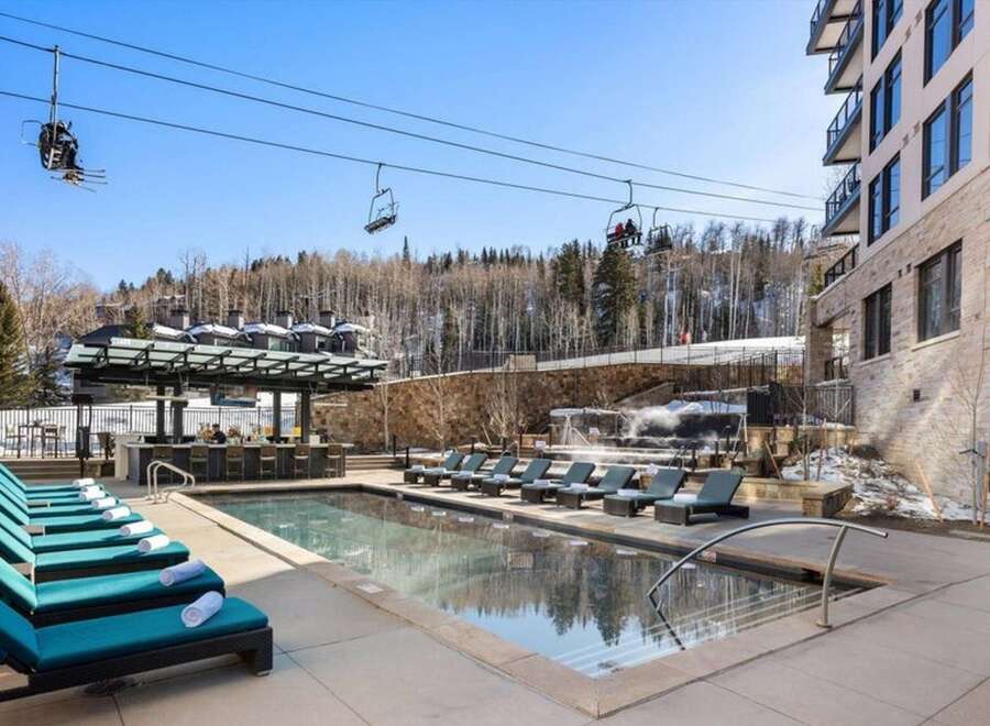 Enjoy luxury living with this stunning property featuring a beautiful outdoor pool and a relaxing hot tub.