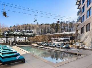 Enjoy luxury living with this stunning property featuring a beautiful outdoor pool and a relaxing hot tub.