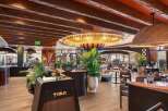 Step into the inviting ambiance of this stunning restaurant, showcasing a blend of modern design and natural elements.