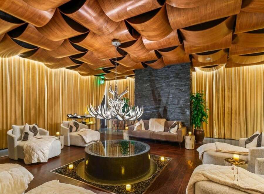 Step into luxury with this stunning property featuring a unique, artistic ceiling design.