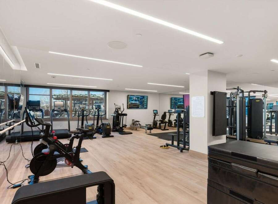 This modern gym offers a comprehensive fitness experience with a variety of equipment.