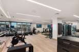 This modern gym offers a comprehensive fitness experience with a variety of equipment.