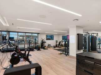 This modern gym offers a comprehensive fitness experience with a variety of equipment.