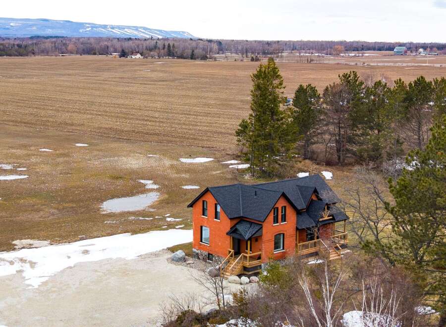 This stunning brick home offers a perfect blend of classic charm and modern comfort.