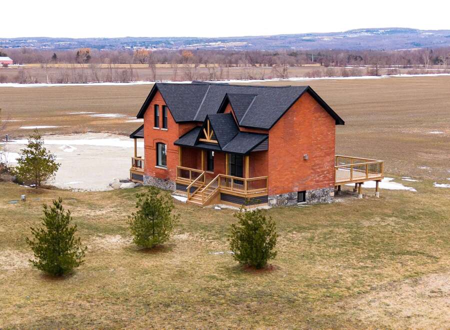 This stunning brick home offers a perfect blend of classic charm and modern design.