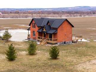 This stunning brick home offers a perfect blend of classic charm and modern design.