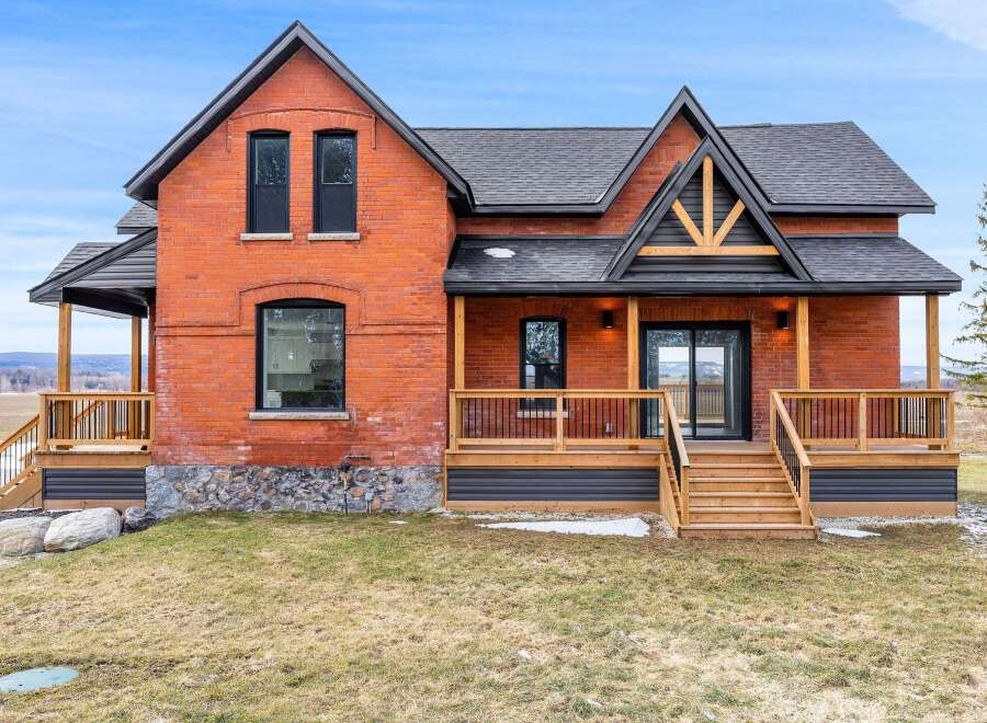 This stunning brick home offers a perfect blend of classic charm and modern design.