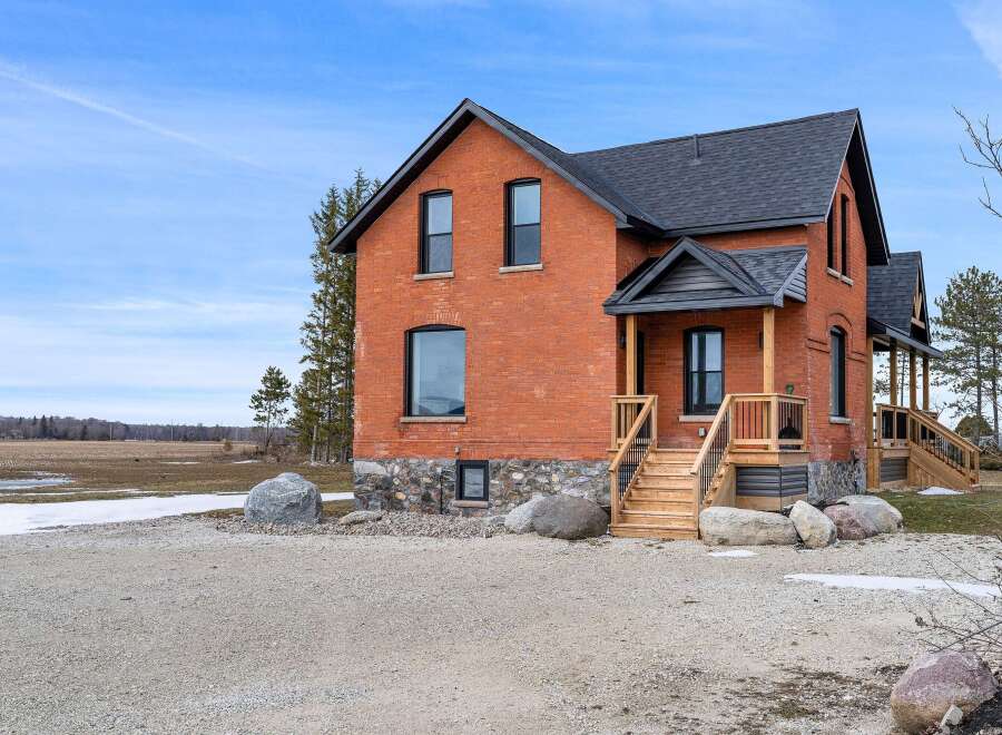 This stunning brick home offers a perfect blend of classic charm and modern elegance.