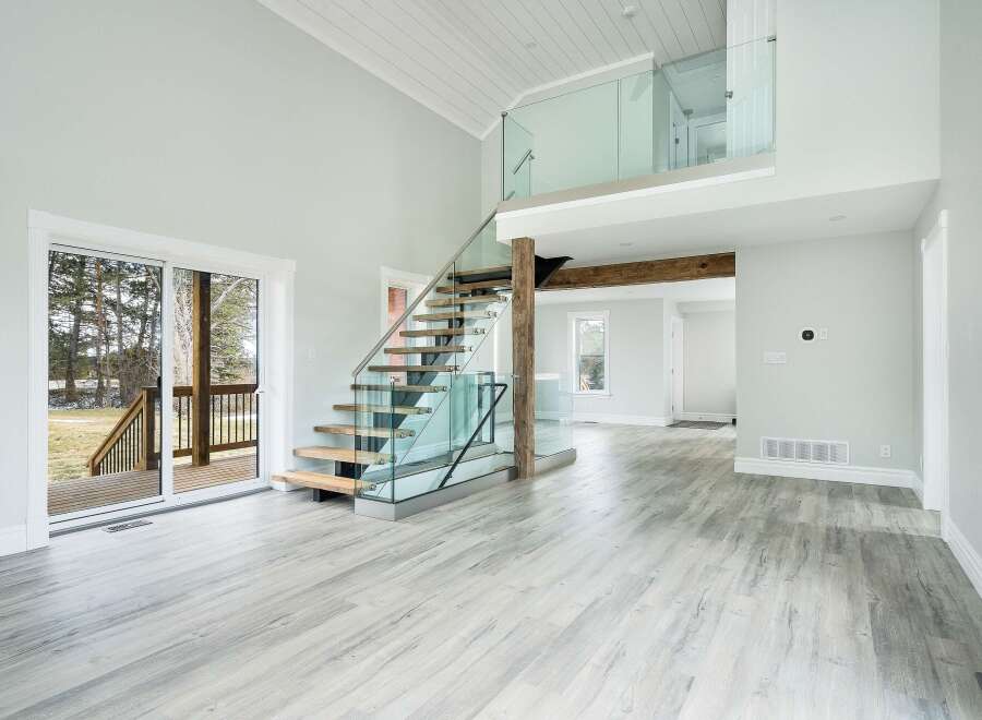 This stunning property boasts a modern interior with a grand staircase and a spacious open floor plan.