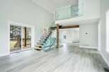 This stunning property boasts a modern interior with a grand staircase and a spacious open floor plan.