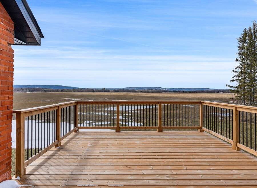 Enjoy breathtaking views from this stunning property! This home features a spacious wooden deck, perfect for relaxing and entertaining.