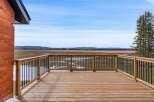 Enjoy breathtaking views from this stunning property! This home features a spacious wooden deck, perfect for relaxing and entertaining.