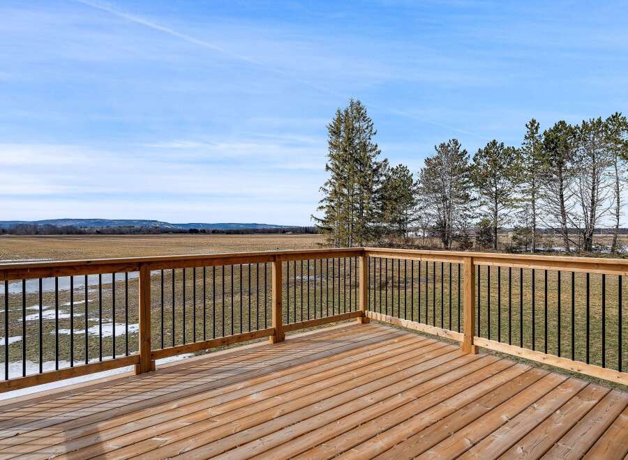 Enjoy breathtaking views from this stunning property! This home features a spacious wooden deck, perfect for relaxing and entertaining.