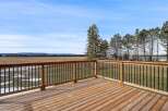 Enjoy breathtaking views from this stunning property! This home features a spacious wooden deck, perfect for relaxing and entertaining.