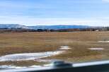 This stunning property offers breathtaking views of a vast, open field, perfect for those seeking tranquility and space.