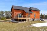 This stunning brick home boasts a beautiful wooden deck, perfect for enjoying the outdoors.