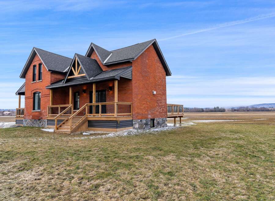 This stunning brick house offers a blend of classic charm and modern design, perfect for those seeking a unique property.