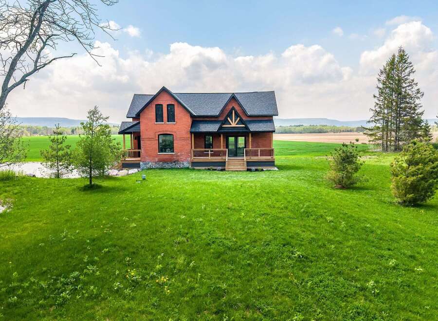 This stunning property features a beautiful brick house with a charming design.