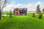 This stunning property features a beautiful brick house with a charming design.