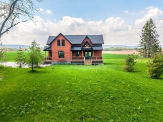 This stunning property features a beautiful brick house with a charming design.