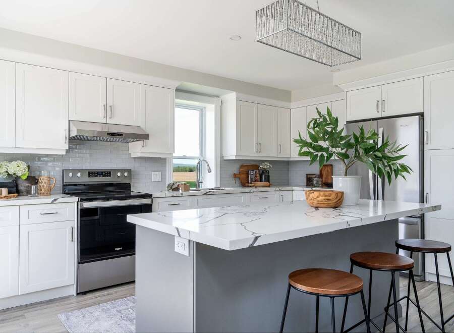 This stunning kitchen boasts a modern design with sleek white cabinetry and a spacious island, perfect for both cooking and entertaining.