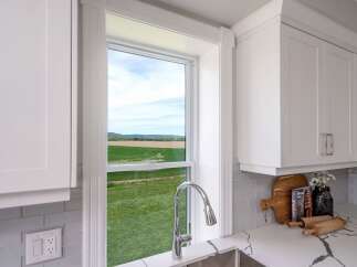 This stunning kitchen boasts a bright and airy feel, perfect for culinary enthusiasts.