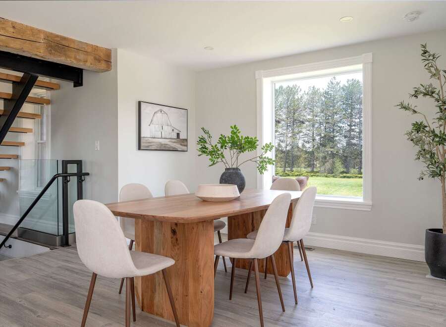 This stunning dining room boasts a modern aesthetic with a touch of rustic charm.