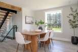 This stunning dining room boasts a modern aesthetic with a touch of rustic charm.
