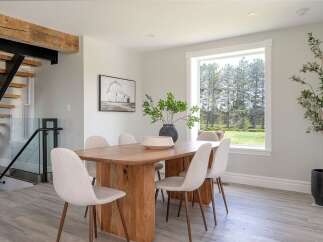 This stunning dining room boasts a modern aesthetic with a touch of rustic charm.