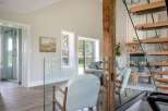 This stunning property boasts a modern interior with a rustic touch, featuring a beautiful wooden beam and a cozy fireplace.