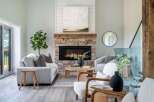 Step into luxury with this stunning living room, featuring a cozy fireplace and elegant decor.