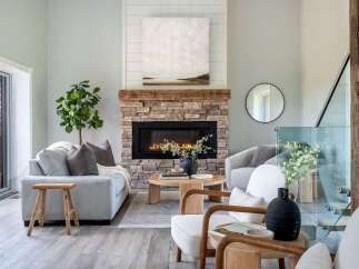 Step into luxury with this stunning living room, featuring a cozy fireplace and elegant decor.