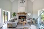 Step into luxury with this stunning living room, featuring a cozy fireplace and elegant design.
