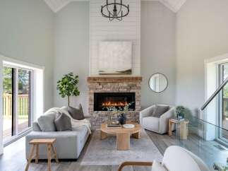 Step into luxury with this stunning living room, featuring a cozy fireplace and elegant design.