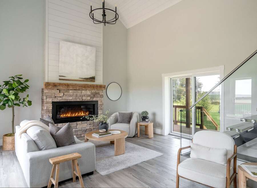 Step into luxury with this stunning living space, featuring a cozy fireplace and a modern, open design.