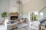 Step into luxury with this stunning living space, featuring a cozy fireplace and a modern, open design.