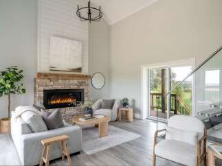 Step into luxury with this stunning living space, featuring a cozy fireplace and a modern, open design.