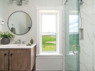 This stunning bathroom boasts a modern design with a touch of nature.