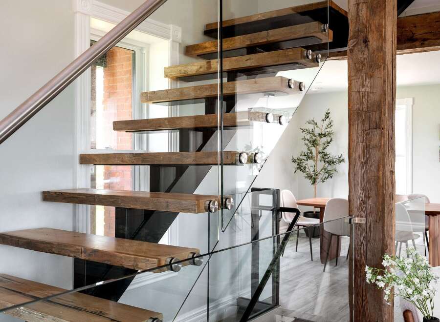 This stunning property boasts a modern staircase with floating wooden steps and sleek glass railings, creating a seamless transition between floors.