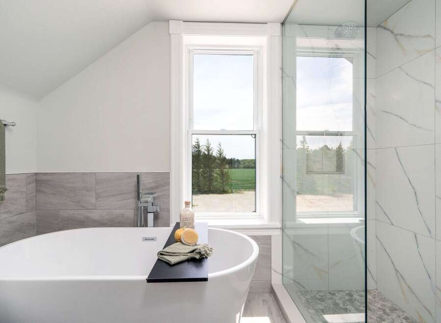 Indulge in the luxury of this stunning bathroom, featuring a sleek, modern soaking tub.