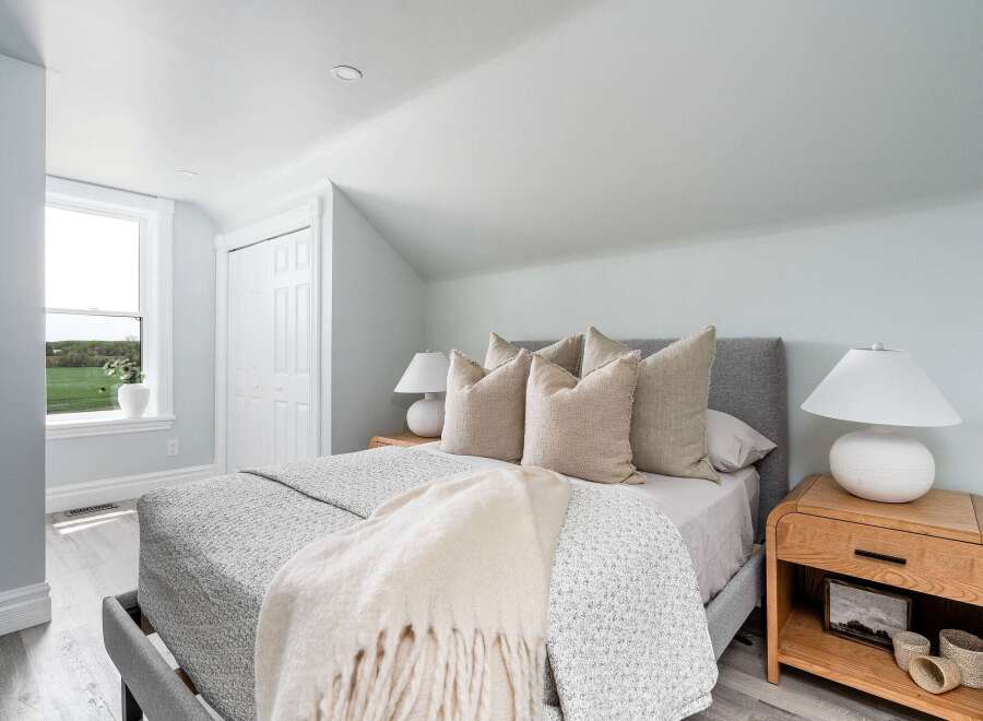 This serene bedroom offers a tranquil retreat with its soft color palette and natural light.