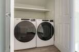This laundry room features a modern Whirlpool washer and dryer set, perfect for efficient laundry days.
