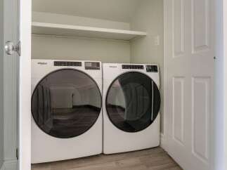 This laundry room features a modern Whirlpool washer and dryer set, perfect for efficient laundry days.