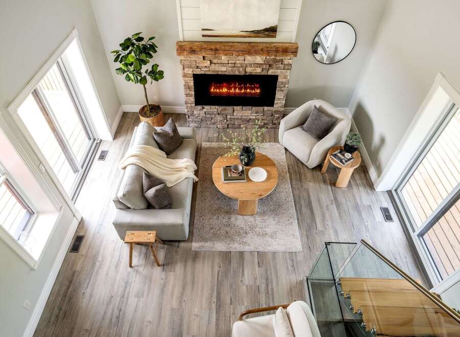 Step into luxury with this stunning property, featuring a cozy living room centered around a beautiful fireplace.