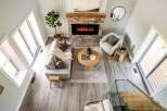 Step into luxury with this stunning property, featuring a cozy living room centered around a beautiful fireplace.