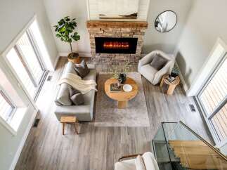 Step into luxury with this stunning property, featuring a cozy living room centered around a beautiful fireplace.