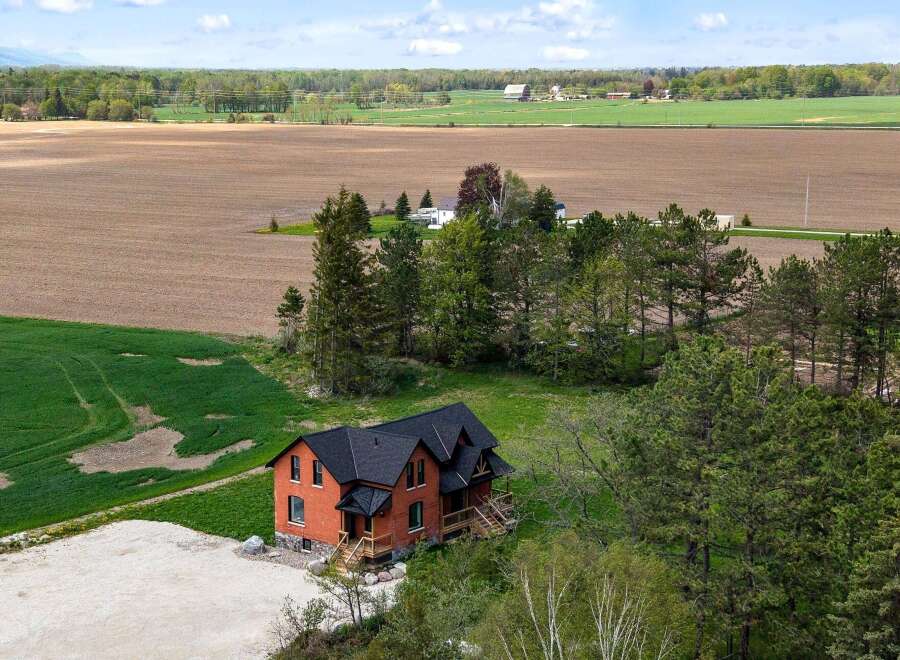 Discover this stunning brick home nestled on a sprawling property, offering a perfect blend of rustic charm and modern comfort.