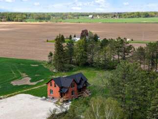 Discover this stunning brick home nestled on a sprawling property, offering a perfect blend of rustic charm and modern comfort.